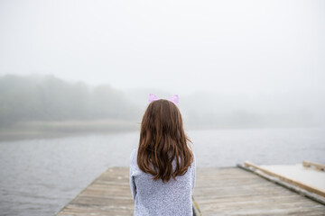 Girl looking at water and fog