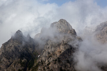 Teton mountains with a storm cloud