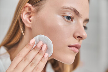 Young female with natural healthy fresh skin at home bathroom
