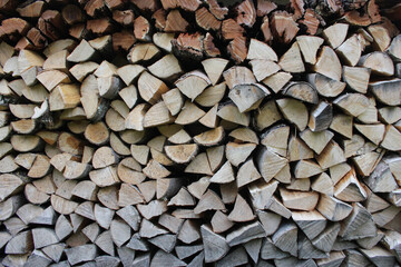 Stacked firewood close-up. Firewood storage. Stocks of wooden logs in the village. Country side lifestyle during winter season.
