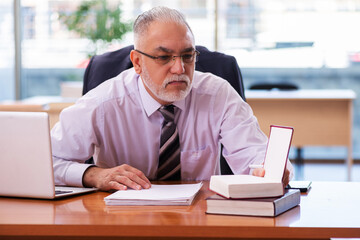 Old businessman employee working in the office