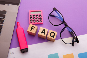 Wooden blocks with word FAQ close-up. Frequently asked question.