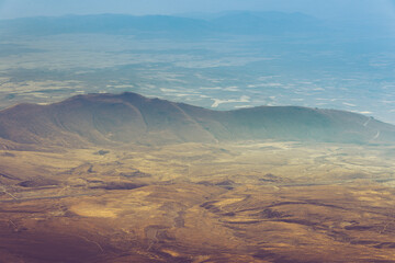 Amazing aerial view of desert, stone hills, and distant mountains layers range.Wilderness background. Vintage toning effect. Near Mount Erciyes. Kayseri, Turkey.