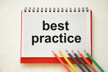 best practice text written on a white piece of paper near colored pencils