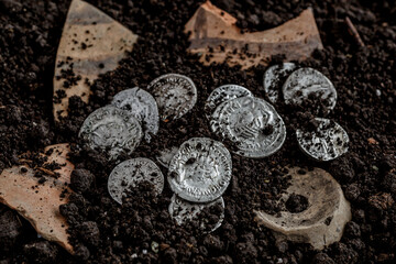 Ancient coin of the Roman Empire.Authentic silver denarius, antoninianus of ancient Rome.Roman silver coins covered in dirt.Antikvariat.
