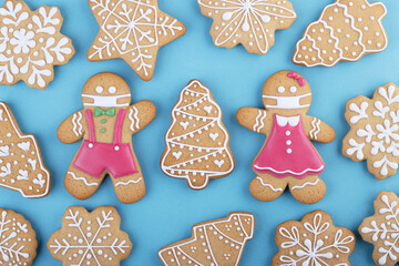 gingerbread man in a ginger cookie face mask iced sugar decoration on a blue background