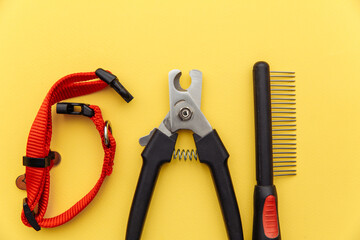 Pet care concept. Tools for grooming isolated on a yellow background.