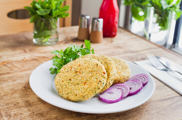 Chickpea Vegan burger raw before cooking -  recipe with chickpeas, onion, parsley and spices. The healthy takeaway, alternative fast food.