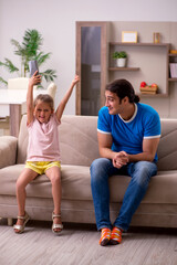 Young man with his daughter at home