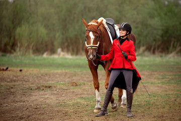 Young woman jockey is riding brown horse, Equestrian sport