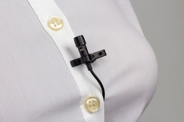 Audio recording of sound on a condenser microphone. The lavalier microphone is secured with a clip...