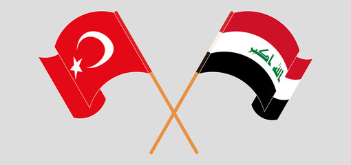 Crossed and waving flags of Turkey and Iraq