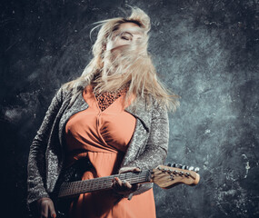 Attractive plump rocker woman with electric guitar