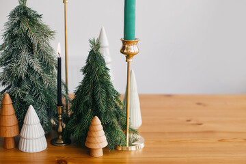 Modern Christmas table decor, stylish christmas trees and candles decorations. Zero waste decor