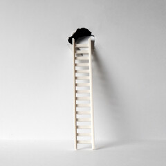 Ladder leaning against the hole in a wall. Escape or exit concept. Square background.