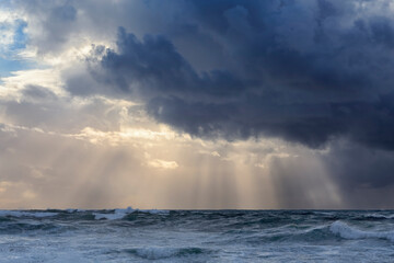 Dramtic cloudscape with sunbeams at sea