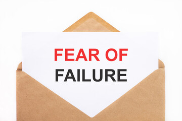 A white sheet with the text fear of failure lies in an open craft envelope on a white background with copy space. Business concept image