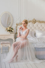 Morning of a beautiful young bride in a boudoir dress.