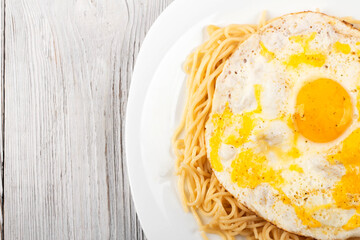 scrambled eggs with pasta on a white plate