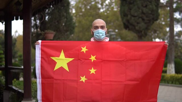 man with mask and flag of china