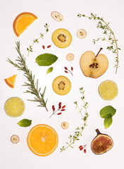 Fruit slices on the white plastic background