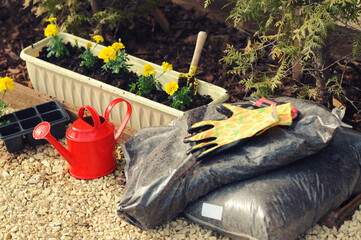Gardering theme: watering can, seedling, flowers in a pot, fertile soil, fertilizer, packaging,...