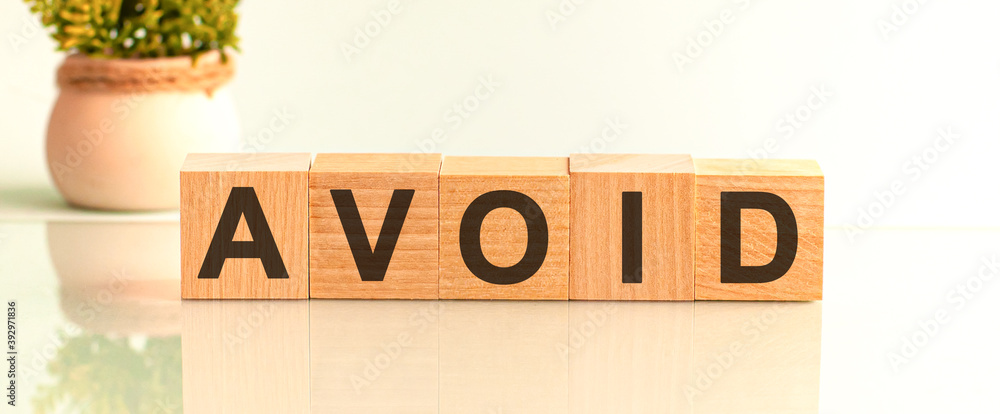 Poster avoid motivation text on wooden blocks business concept white background. front view concepts, flowe