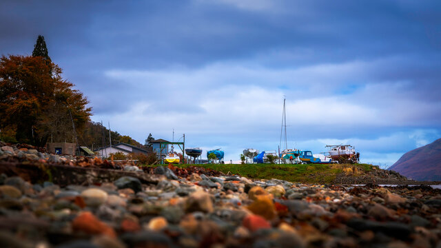 Low angle shot of boat house in Scotland during sunrise at moody day