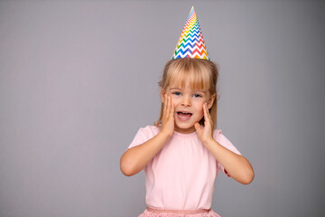 Young beautiful girl in birthday cap over isolated background smiling with happy face