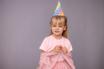 Young beautiful girl in birthday cap over isolated background smiling with happy face