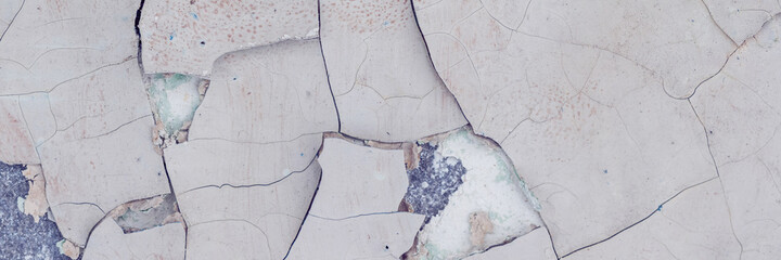 Peeling paint on the wall. Panorama of a concrete wall with old cracked flaking paint. Weathered...