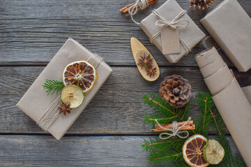 Christmas wooden background with gifts made of natural packaging. Zero waste. Happy New Year. Flat lay