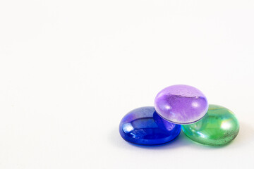 Close up of three colored glass beads