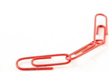 Close up of three linked pink paperclips