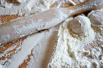 Homemade dumplings on the table in flour. Rolling pin.