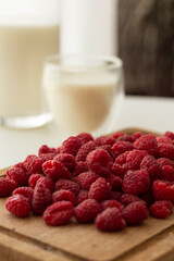 Healthy breakfast is fresh organic raspberries, strawberries with milk jug on an old wooden background. Rustic style.
