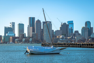 A wrapped sailboat sits idle in East Boston
