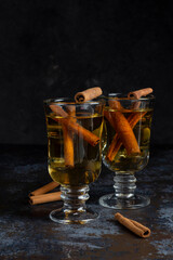 Christmas mulled wine on dark background. Hot alcohol drink cinamon
