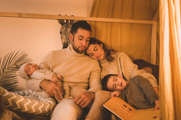 Young family with children in teepee room sleeping