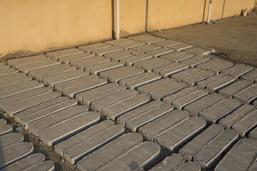 Rectangular grey paving stones arranged in a geometric pattern forming a textured walkway in Oman.