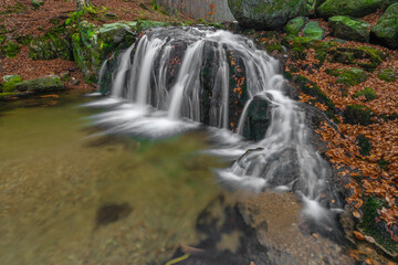 Fototapeta na wymiar Maly Bily Stolpich waterfall in autumn fresh morning in Jizerske mountains
