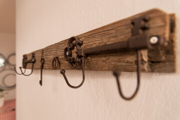 antique wooden coat rack hanging on white wall