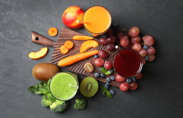 Delicious colorful juices in glasses and fresh ingredients on black table, flat lay