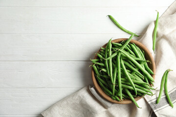 Fresh green beans on white wooden table, flat lay. Space for text