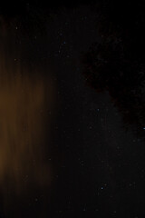 A Night Sky Full of Stars and Orange Clouds
