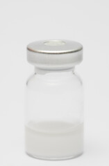 vaccine in glass taro, closed isolated on white background