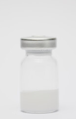 vaccine in glass taro, closed isolated on white background