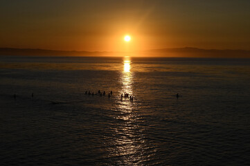 Fototapeta premium surfers at sunrise
