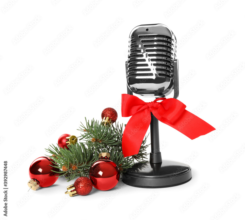 Wall mural Retro microphone with red bow and festive decor on white background. Christmas music