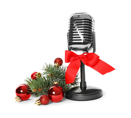 Retro microphone with red bow and festive decor on white background. Christmas music